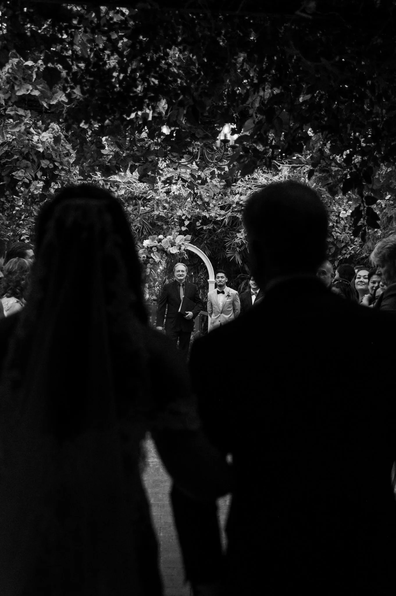 Jeff McQueen waiting at the floral arch as the couple walks down the aisle